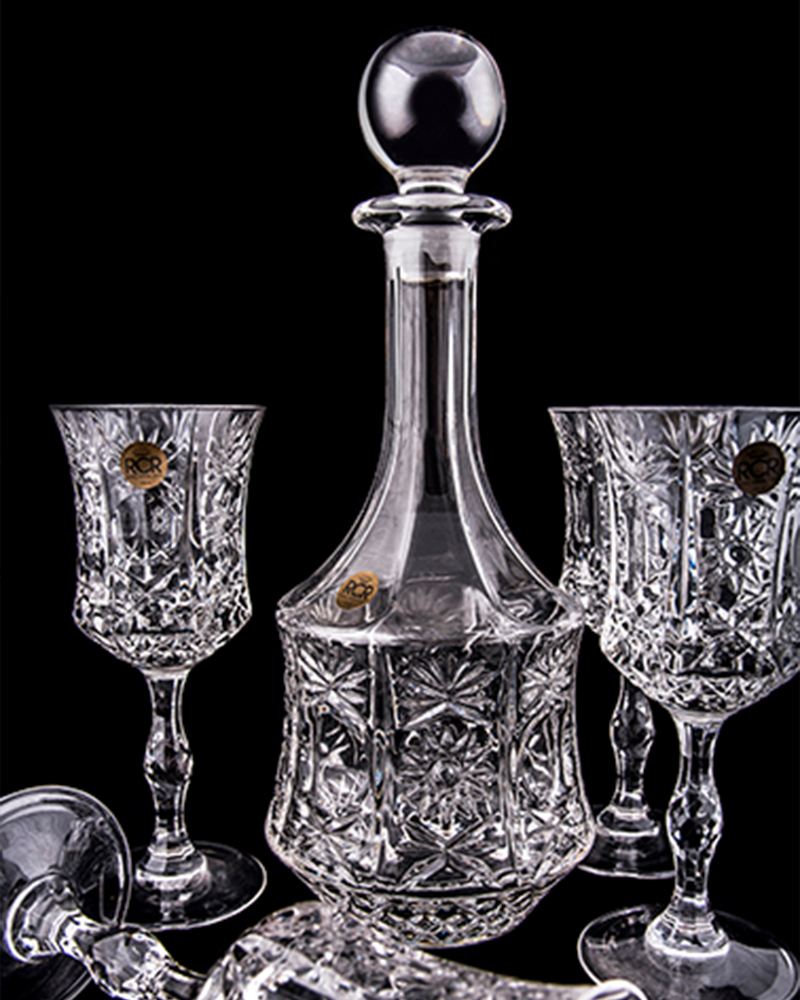 Cut-crystal decanter and glasses on black
