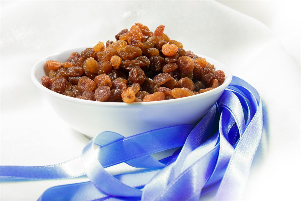 A bowl of raisins with a blue ribbon
